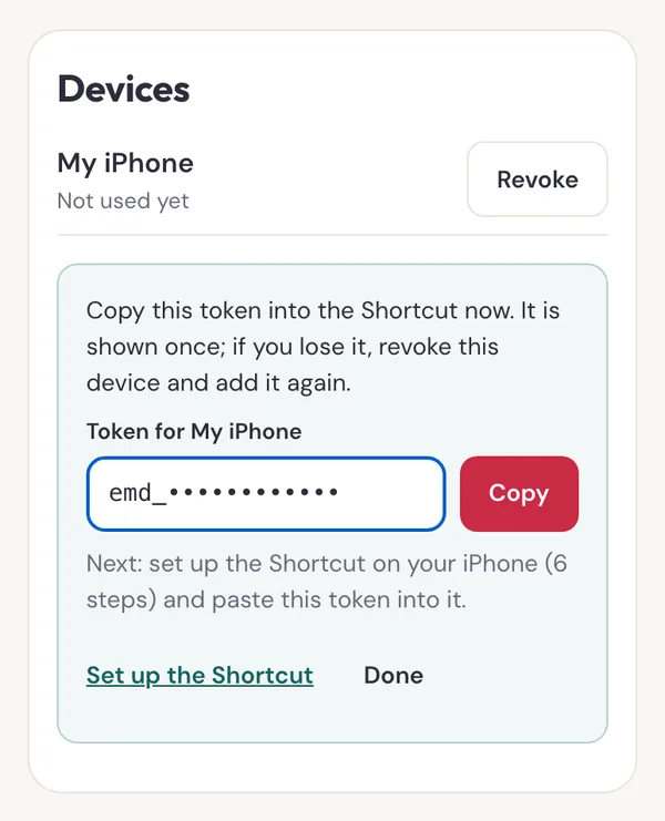The Devices card after Add iPhone, showing a token field starting emd_ with a Copy button and a note that it is shown once